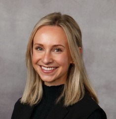 brown hair women black shirt smiling for headshot