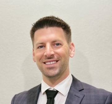 man headshot blonde hair smiling