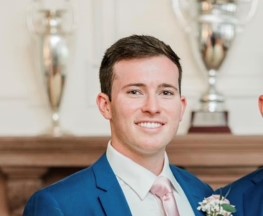 blue suite white shirt smiling man