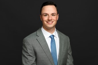 man smiling in grey suite