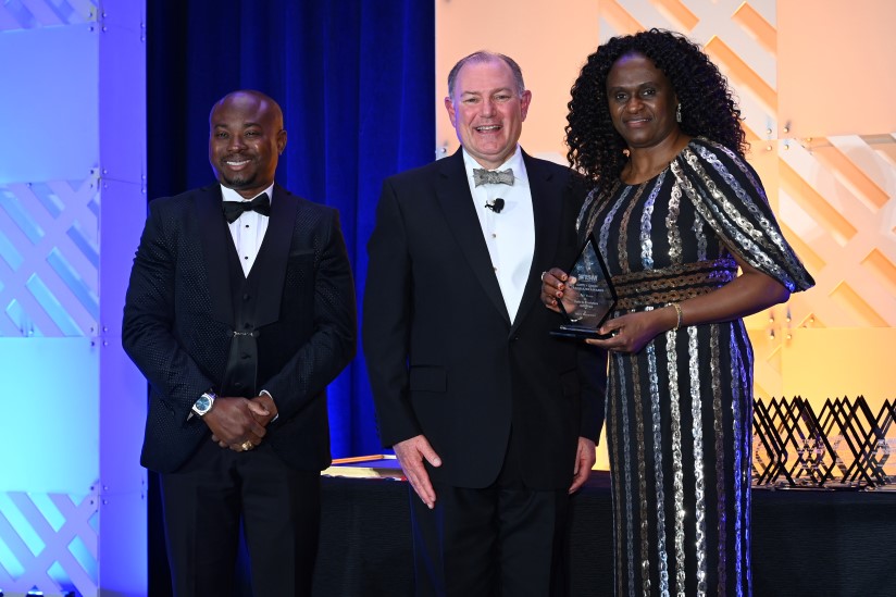 award winners holding award on stage