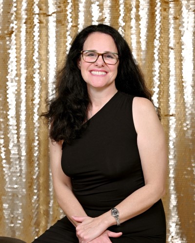 women in black dress smiling headshot