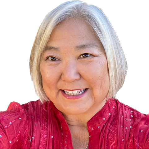 Ann Oka women smiling at camera with a pink shirt on with grey hair