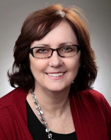 Kimberly DeWitt Women with a purple blazer smiling at the camera